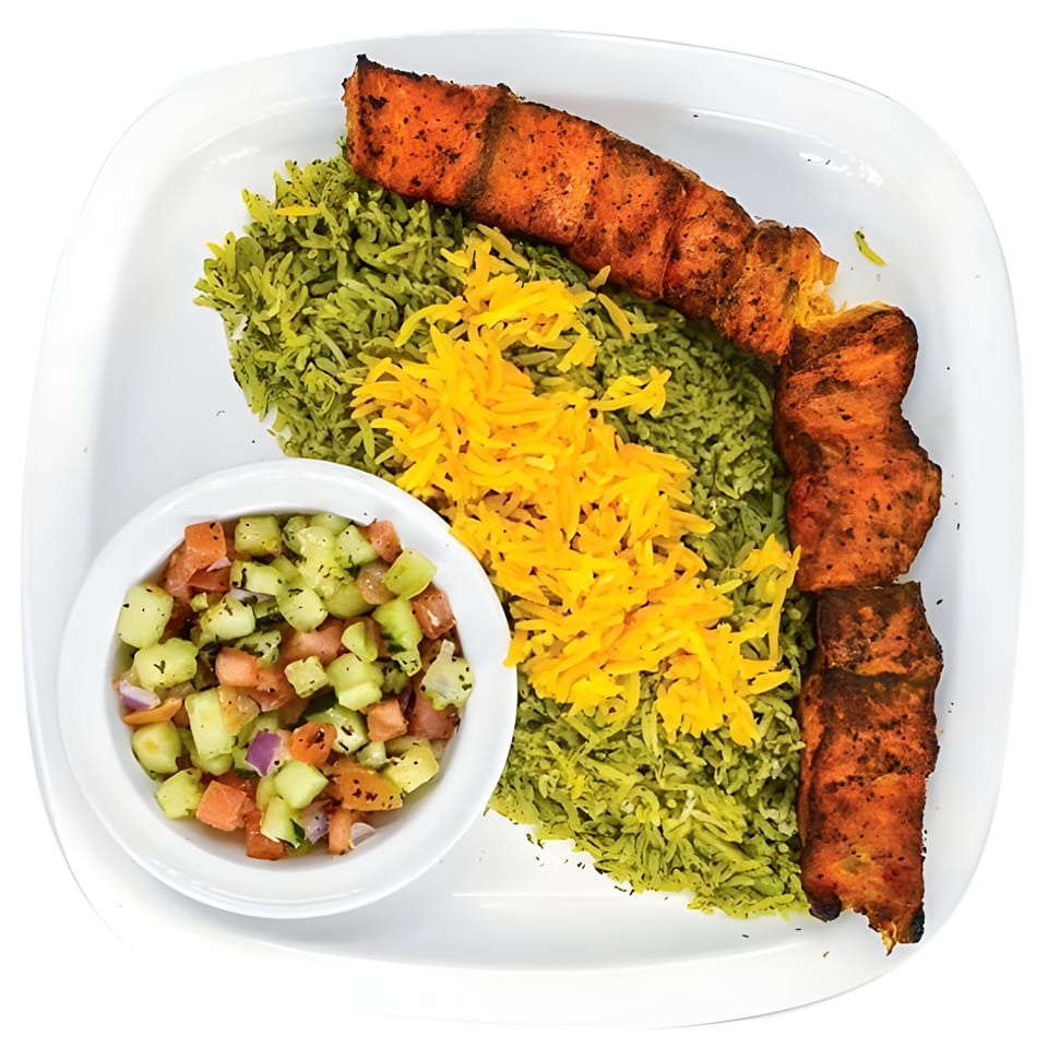 Persian dish with grilled salmon, green rice topped with saffron, and a side of Shirazi salad.